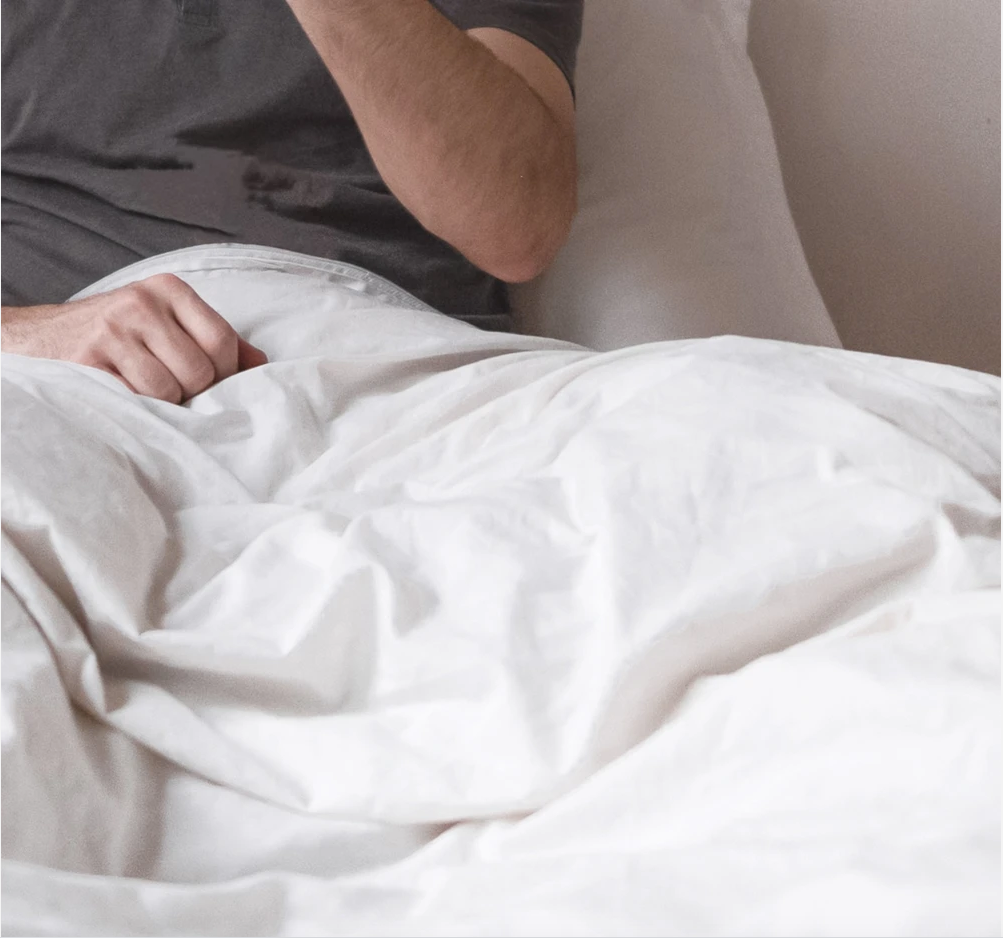 Picture of a couple sat in bed with high thread count supersoft OTTY bedding sheets and pillowcases.