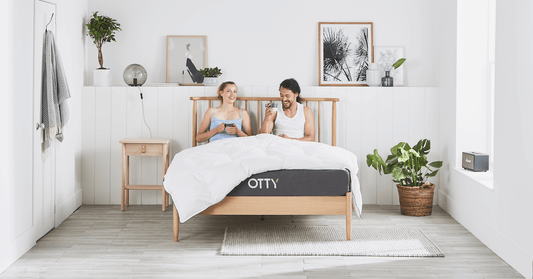 PIcture of a couple in bed having a chat on a hybrid mattress